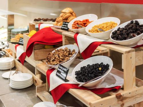 a buffet with bowls of different types of food at Ibis Astana in Astana