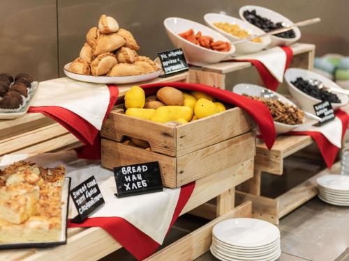 a table with a crate of bread and other foods at Ibis Astana in Astana