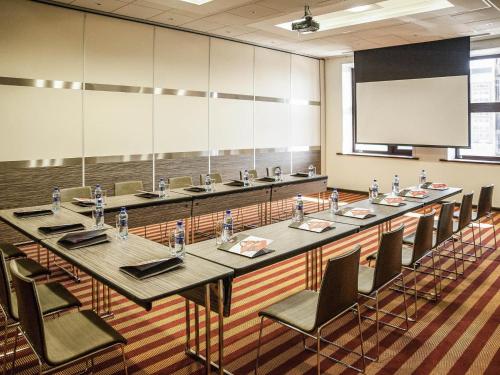 a large conference room with a long table and chairs at Ibis Astana in Astana