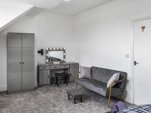 a living room with a couch and a vanity and a mirror at Ocean Breeze in Heysham