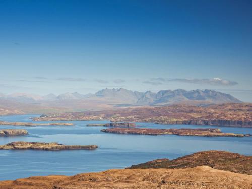 a large body of water with mountains in the background at Taigh Mullach Dearg in Portree