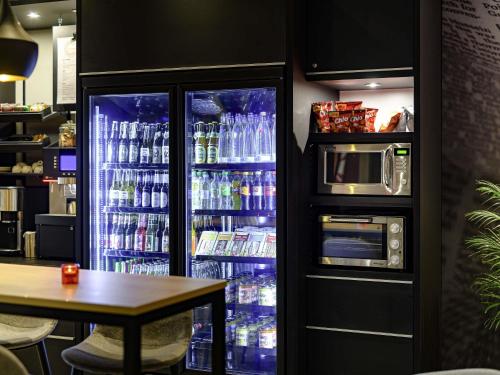 a refrigerator full of water and drinks in a restaurant at Ibis Berlin Hauptbahnhof in Berlin