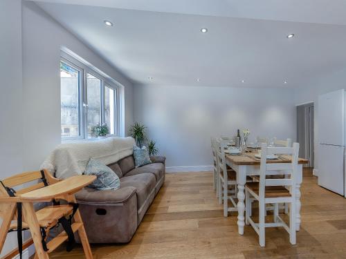 a living room with a couch and a table at Spring Gardens in New Quay