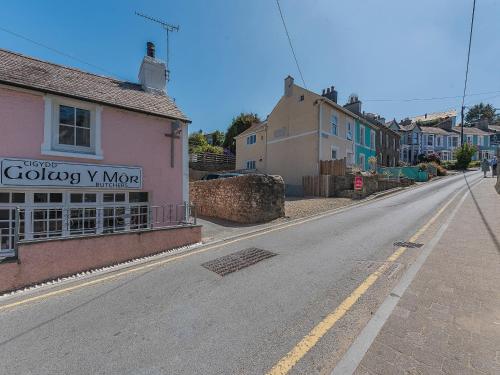 an empty street in a small town with houses at Spring Gardens in New Quay