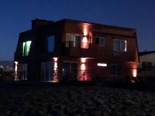a building with lights on it at night at The Shores Inn in Ventura