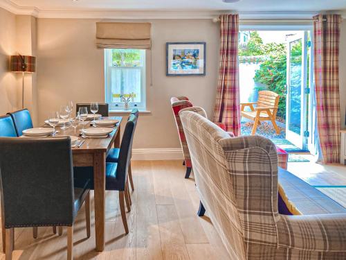 a dining room with a table and chairs at Rye Cottage in Helmsley