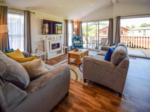 a living room with two couches and a fireplace at Sunnybank in Warton