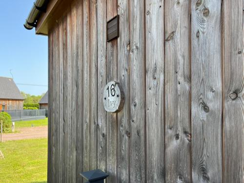 a wooden building with a clock on the side of it at Ivy - Uk50105 in Brigg