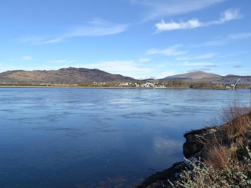 a large body of water with mountains in the background at 4 Dolphins in Connel