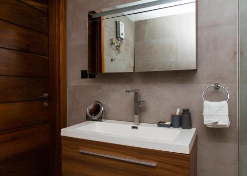 a bathroom with a white sink and a mirror at Asa Beach Villa in Trofwi