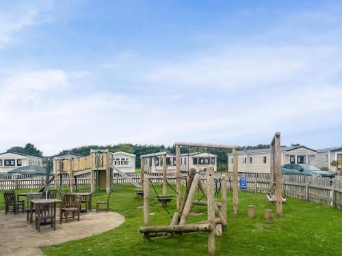 a playground with tables and chairs and houses at Swaledale 5 in Tosside