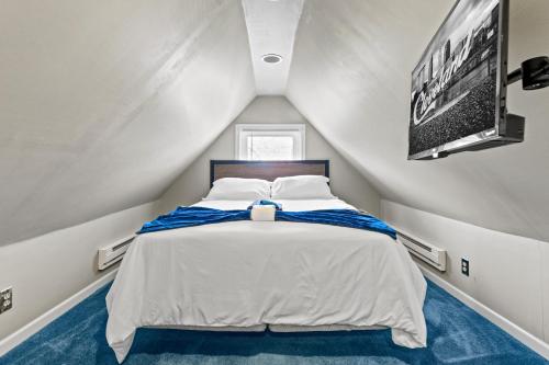 a small bedroom with a bed in a attic at Ohio City 4 Bed 3 TV Free Parking Mins to DT in Cleveland