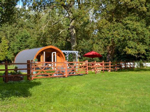 a wooden fence with a tent in a field at Park View - Ukc4925 in Roydon