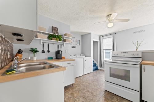 a kitchen with a sink and a stove at Ohio City 4 Bed 3 TV Free Parking Mins to DT in Cleveland
