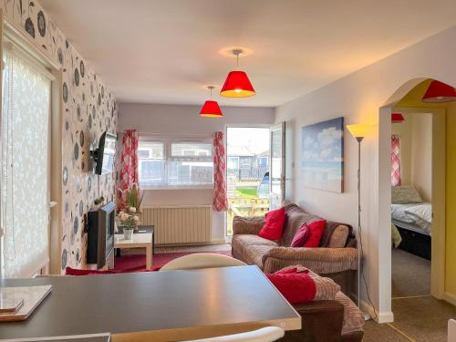 a living room with a couch and a table at Rosie's Cottage in Bridlington