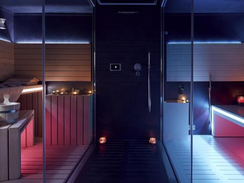 a staircase in a room with neon lights at Mercure Hotel Golf Cap d'Agde in Cap d'Agde