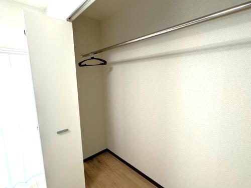 an empty room with a white wall and a light at K2 square 502 in Nagoya