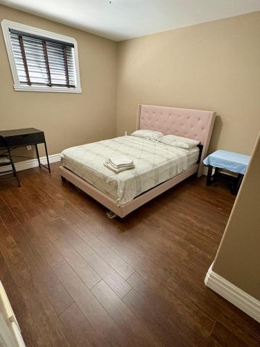 a bedroom with a bed and a table and a window at Home sweet home in Windsor