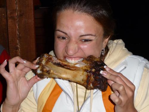 a woman eating a large piece of food at Penzion HANA in Albrechtice v Jizerských horách