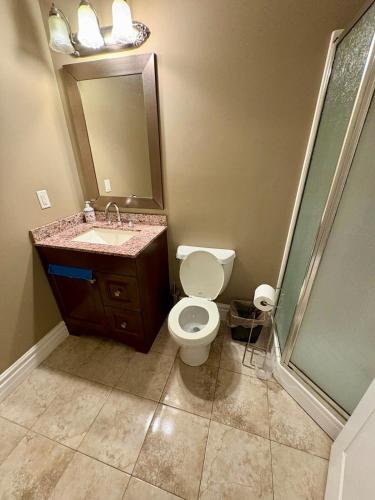 a bathroom with a toilet and a sink and a shower at Home sweet home in Windsor