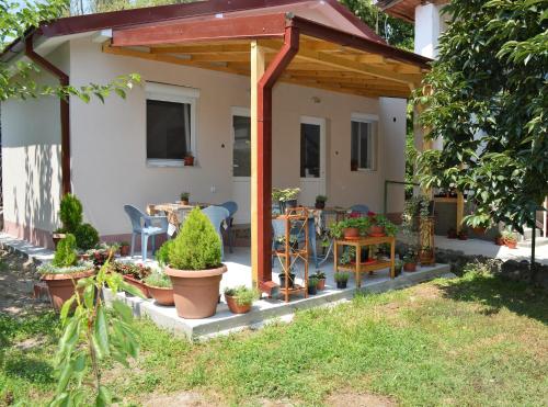 a pergola in the backyard of a house with plants at Apartments Pinikot in Star Dojran
