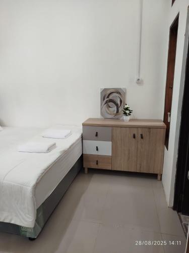 Ένα ή περισσότερα κρεβάτια σε δωμάτιο στο Favian Homestay