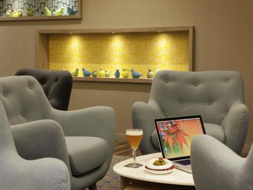 a room with two chairs and a table with a laptop at ibis Styles Chaumont Centre Gare in Chaumont