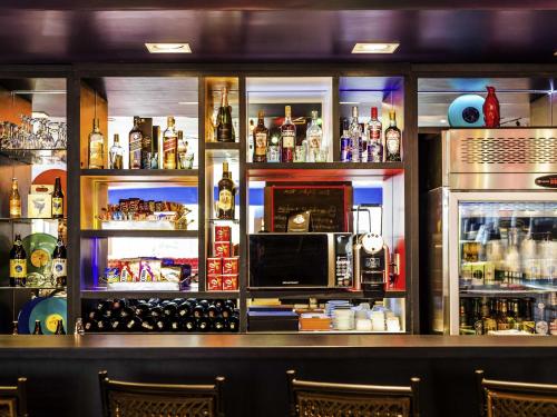 a bar filled with lots of bottles of alcohol at Ibis Styles Porto Alegre Centro in Porto Alegre