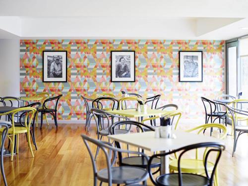 an empty dining room with tables and chairs at ibis Styles Barnsley in Barnsley