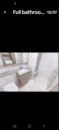a white marble bathroom with a sink in a room at Eaton kl,2R1B 0Service,klcc,500mbps,2-4pax in Kuala Lumpur