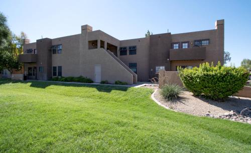 a house with a green lawn in front of it at Stylish Lemon 2BR and 3BA Townhouse in Tempe