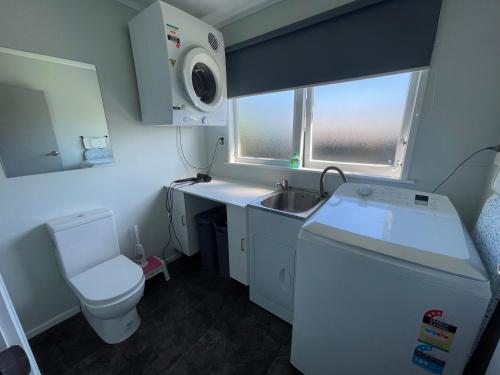 a small bathroom with a sink and a toilet at Homely Gurl in Hamilton