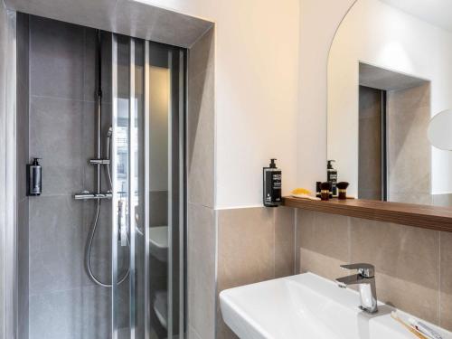 a bathroom with a shower and a sink at Ibis Styles Paris Jardin de la Villette - Rénové en 2025 in Paris