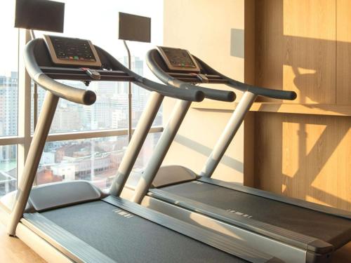 a treadmill with two phones on it in front of a window at ibis Styles Ambassador Seoul Myeong-dong in Seoul