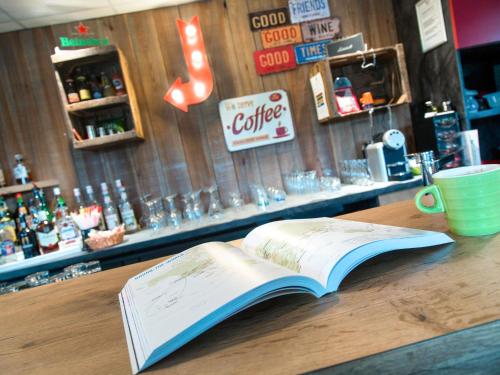 an open book sitting on top of a table at ibis Styles Vierzon in Vierzon