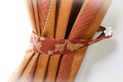 a bunch of bamboo sticks with a brown belt at Sweet Home in Treviso