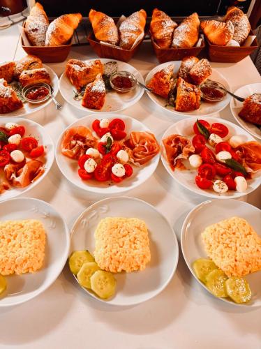 a table with plates of different types of food at B&B Giulia in Taormina