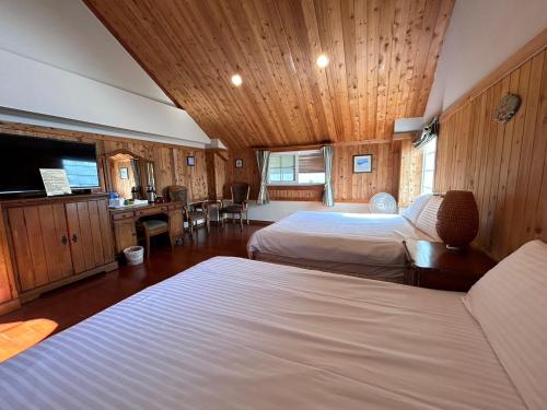a large room with two beds and a television at Euro Country Villa in Renai