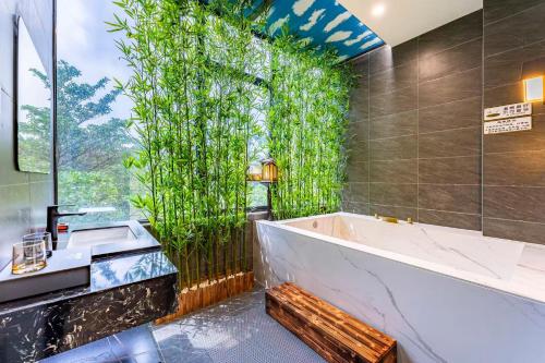 a bathroom with a bath tub and a large window at Dekang Yuexiang Hotel in Guangzhou