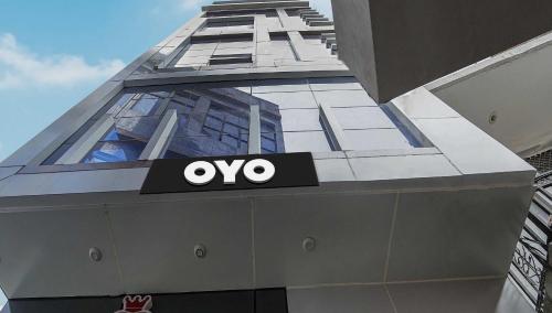 a building with an ovy sign on the side of it at Hotel O SS hotel in Kaliānpur