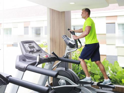 a man on a treadmill in a gym at Novotel Bali Ngurah Rai Airport in Kuta