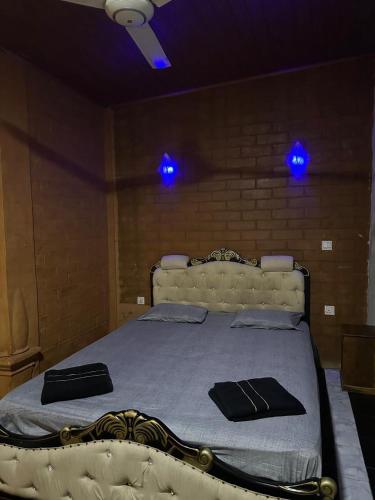 a bedroom with a bed with blue lights on it at Mahagedara Grand Bungalow 