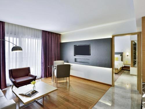 a living room with a couch and a table at Novotel Imagicaa Khopoli in Khopoli