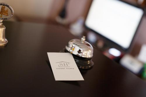 a close up of a table with a shiny silver pocket watch at Sweet Home in Treviso