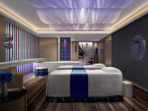a bedroom with a large bed in a room at Pullman Nanjing Lukou Airport in Nanjing