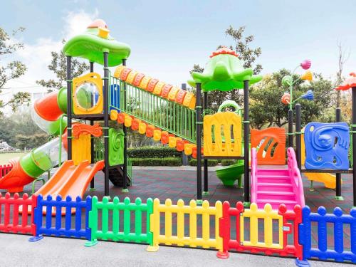 a playground with a colorful slide and slides at Pullman Changshu Leeman in Changshu