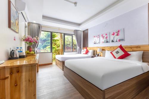 una camera d'albergo con due letti e una finestra di Sapa Florence Homestay & Garden a Sa Pa