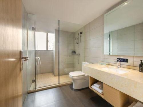 a bathroom with a shower and a toilet and a sink at City Comfort Inn Liuzhou Wuxing Walking Street Zhonghuan Tower in Liuzhou