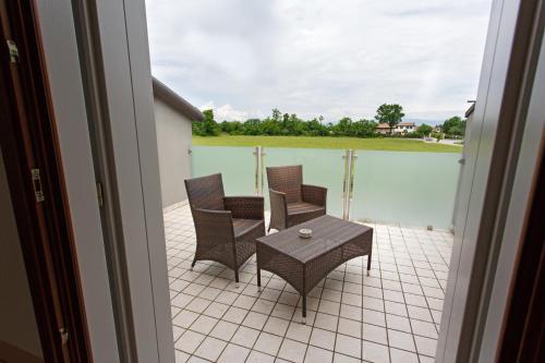 a patio with a table and chairs on a balcony at Sweet Home in Treviso