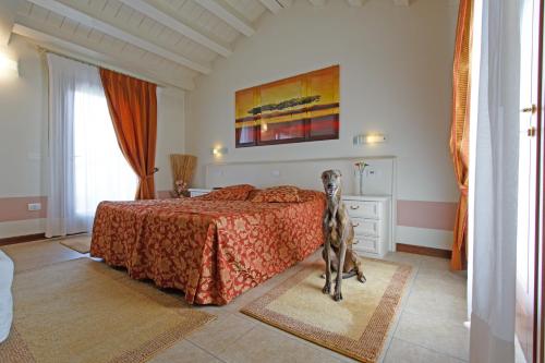 a bedroom with a dog standing next to a bed at Sweet Home in Treviso